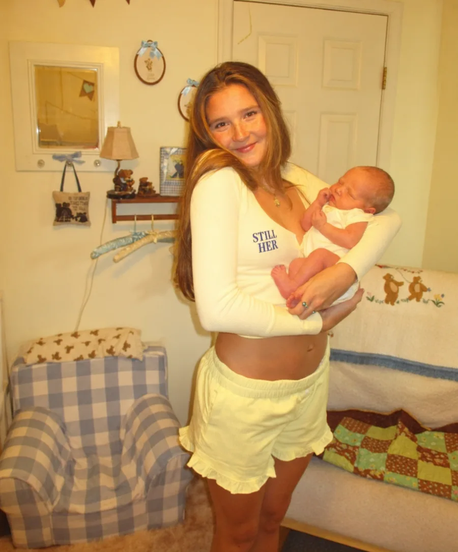 Mother holding her newborn in a warm nursery